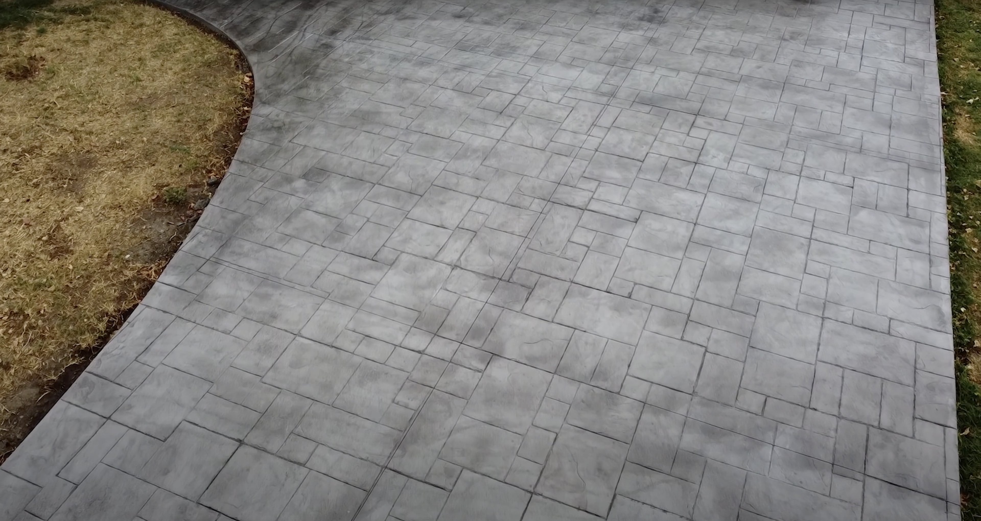 Professional concrete patio installation Modern concrete patio with geometric paver pattern