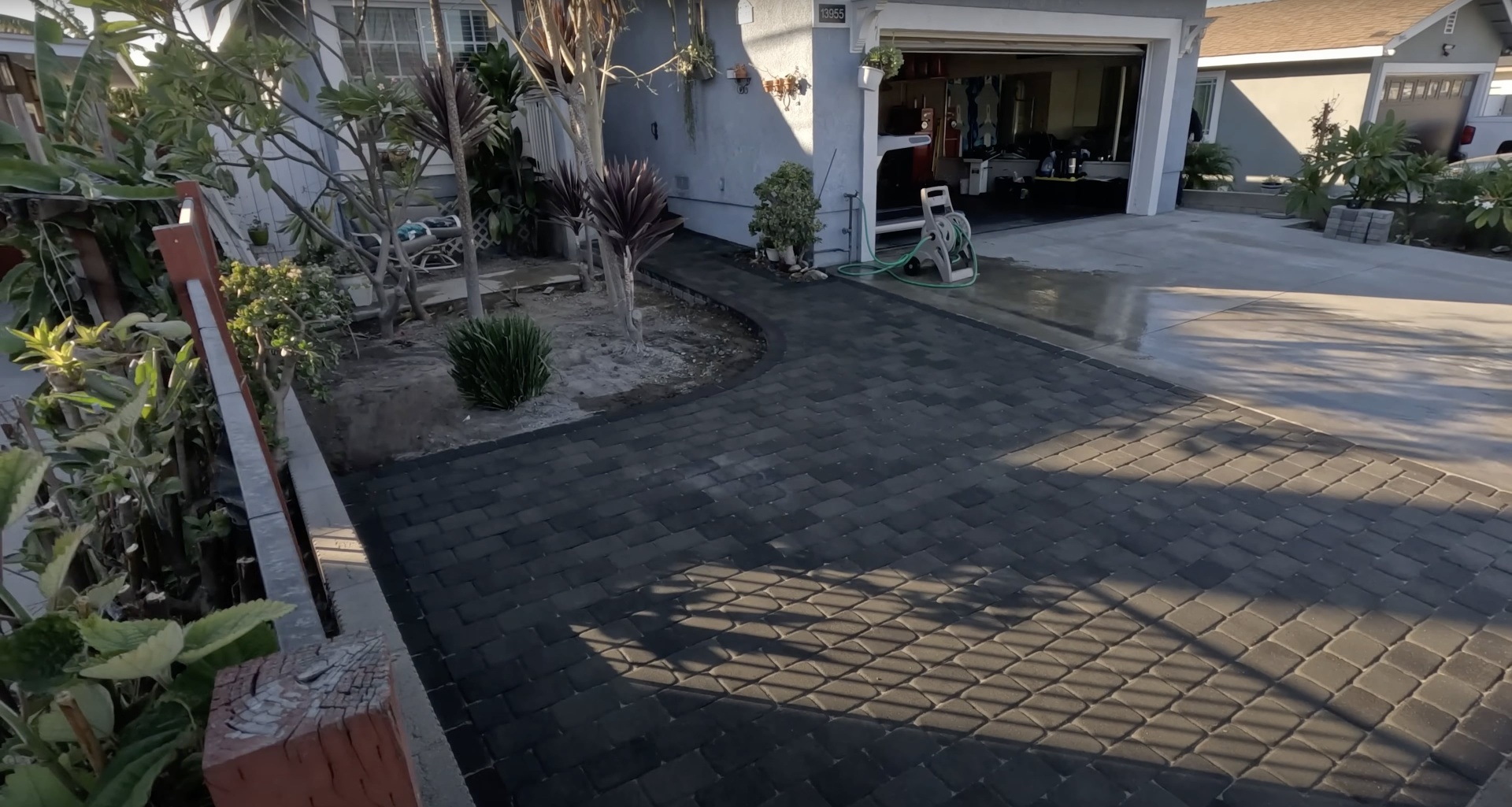Custom concrete driveway and paver design Residential concrete driveway with decorative paver accents
